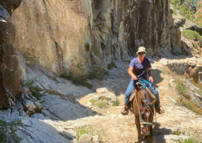 Woman riding on a horse trail at Kennedy Meadows