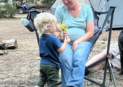 A young boy gives mother flowers at Kennedy Meadows campground